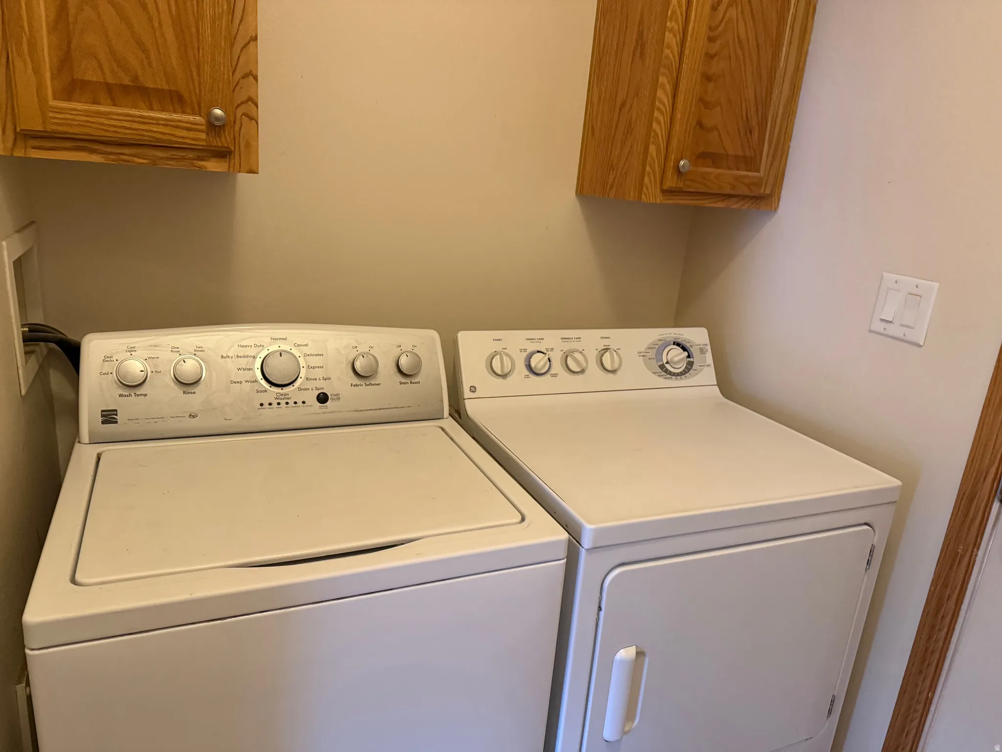 Laundry room featuring cabinet space and washer and clothes dryer