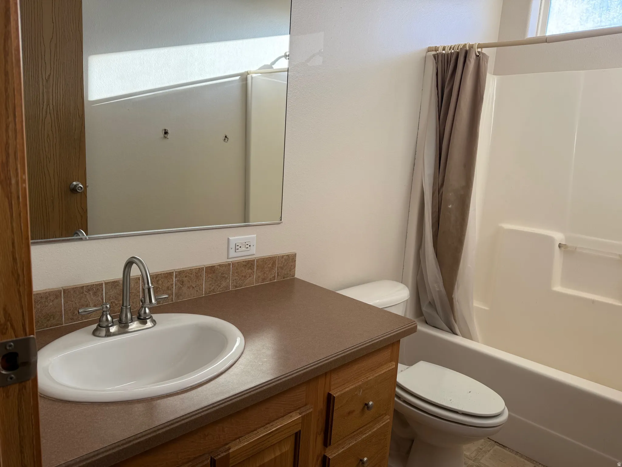 Bathroom with vanity and shower / bath combination with curtain