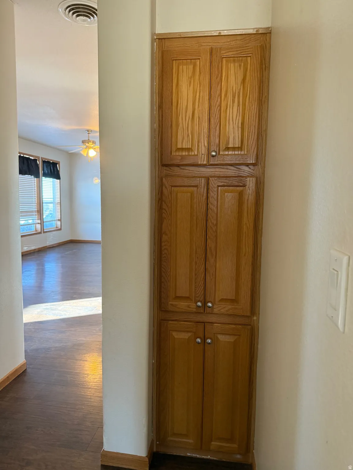 Hall with dark wood finished floors and baseboards
