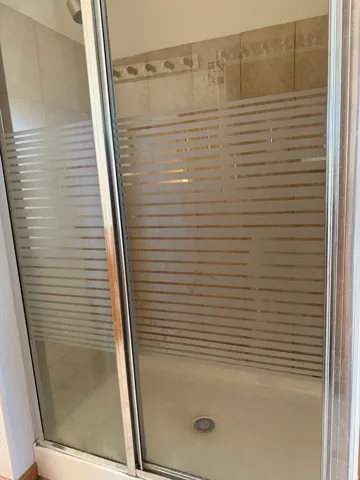 Full bathroom featuring a shower stall