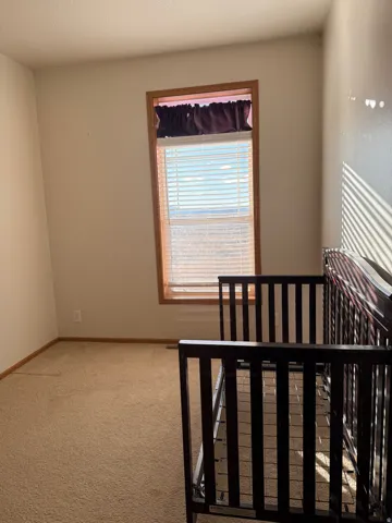 Unfurnished bedroom with light colored carpet and a textured ceiling