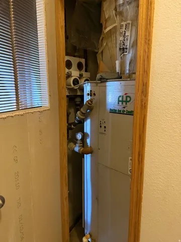 Utility room featuring heating unit