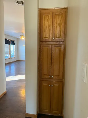 Hall with dark wood finished floors and baseboards