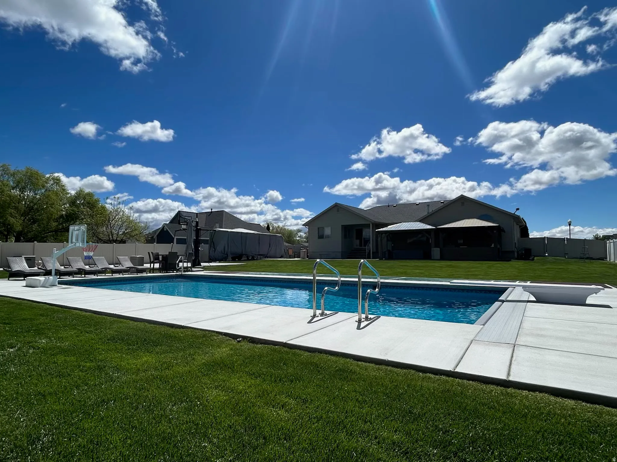 View of pool featuring patio surround and a residential view