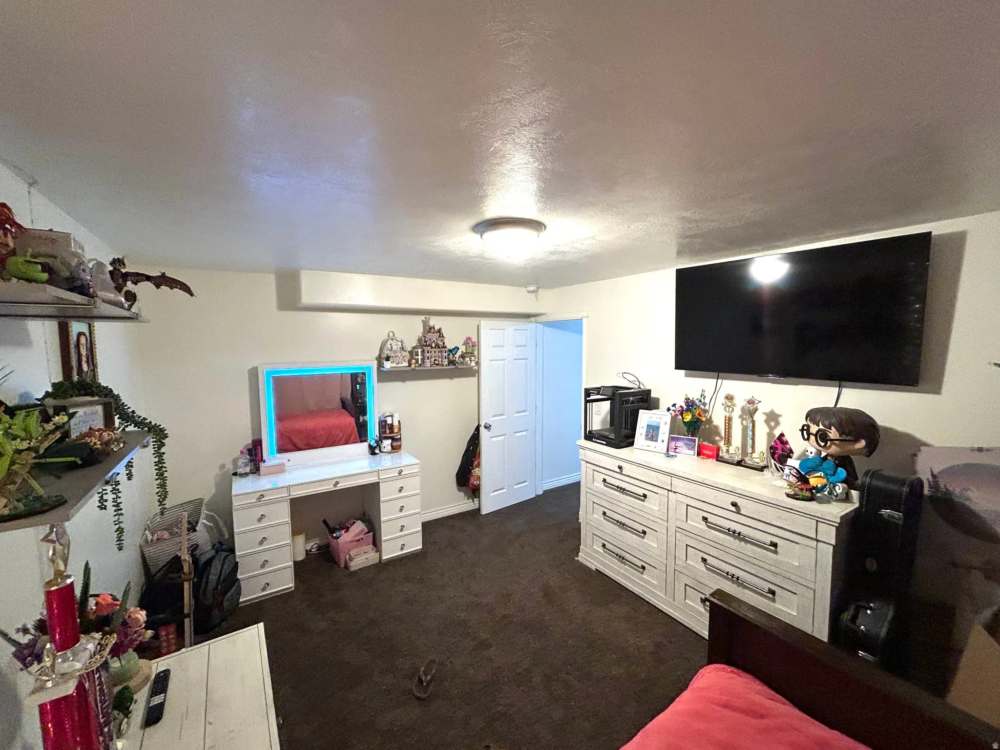 Living area with a textured ceiling and dark carpet