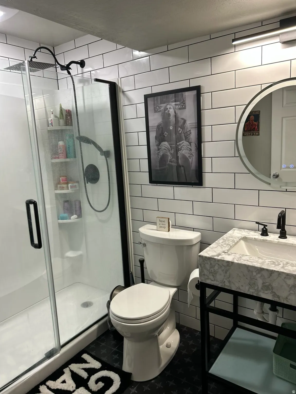 Full bathroom featuring tile walls and a stall shower