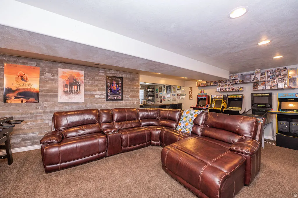 Living area featuring carpet floors, recessed lighting, and a textured ceiling