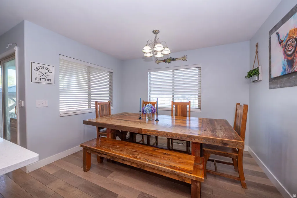 Dining area featuring hardwood / wood-style floors and suspended lighting