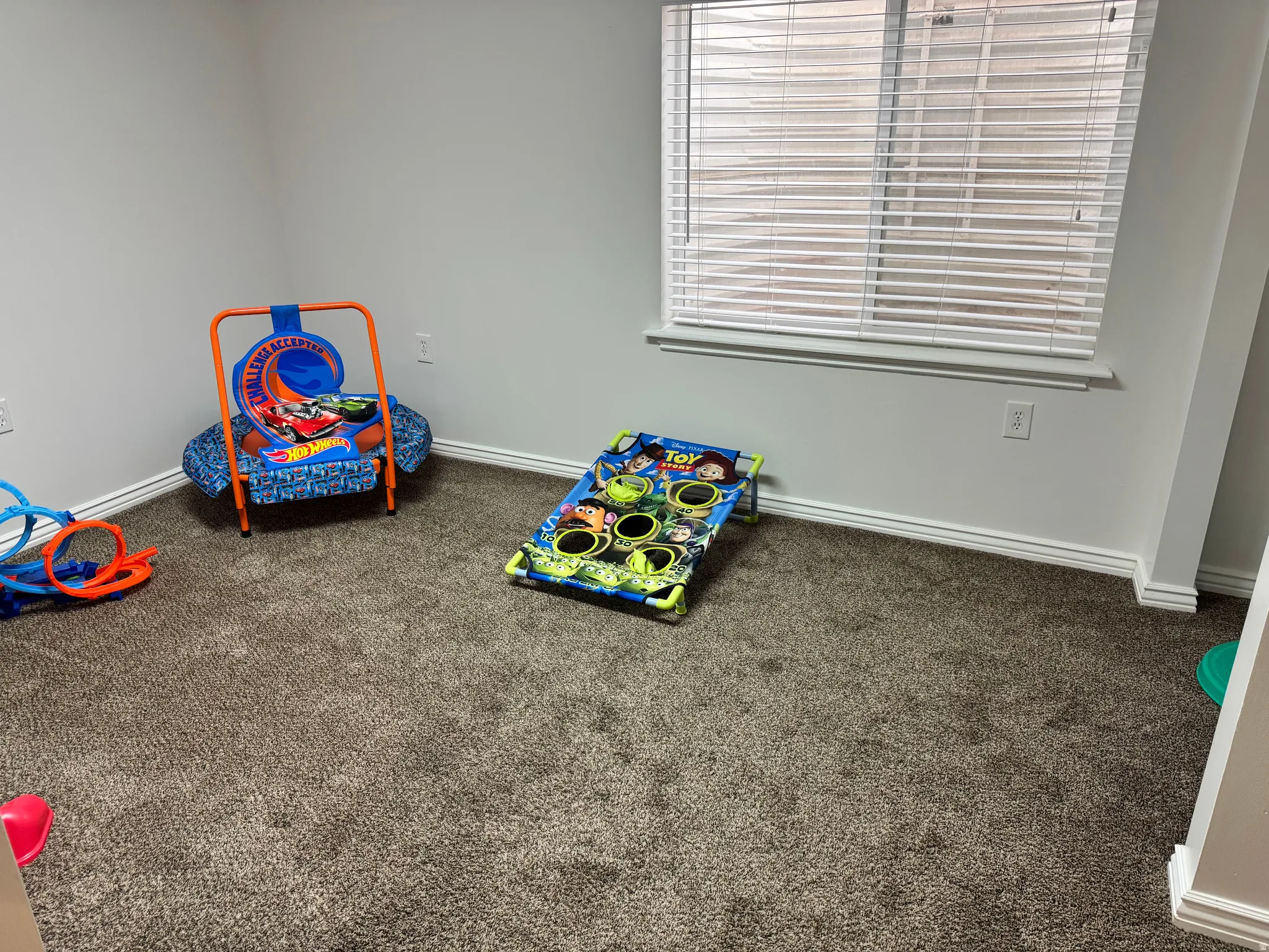 Rec room with dark carpet and baseboards
