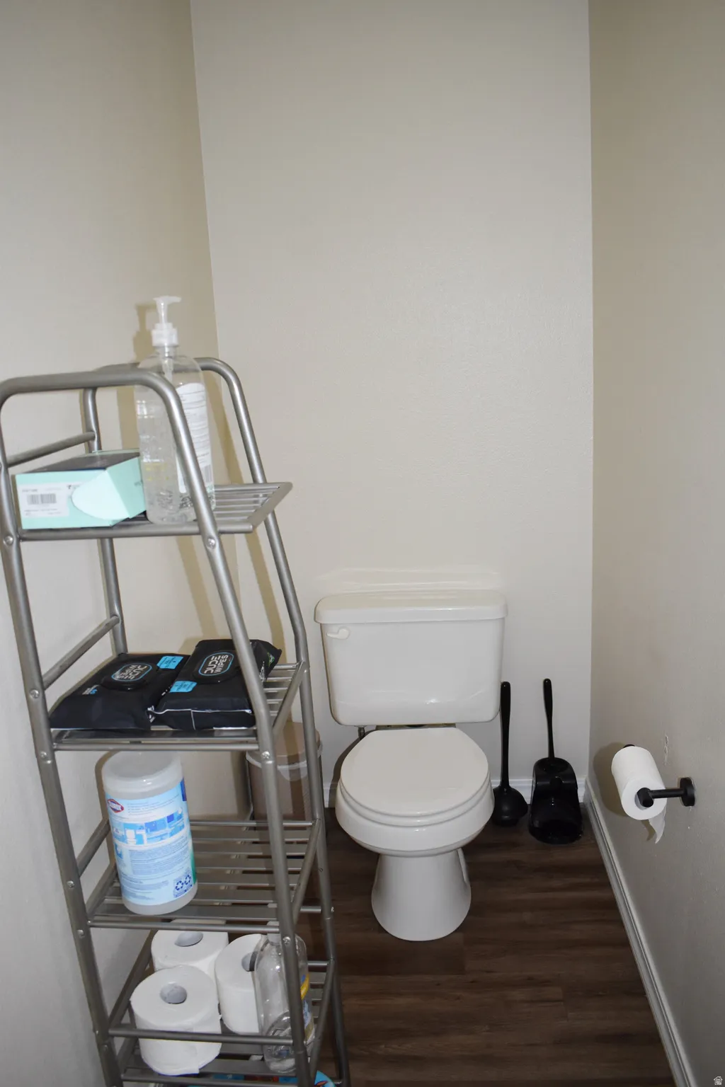 Bathroom with dark wood-style floors and toilet