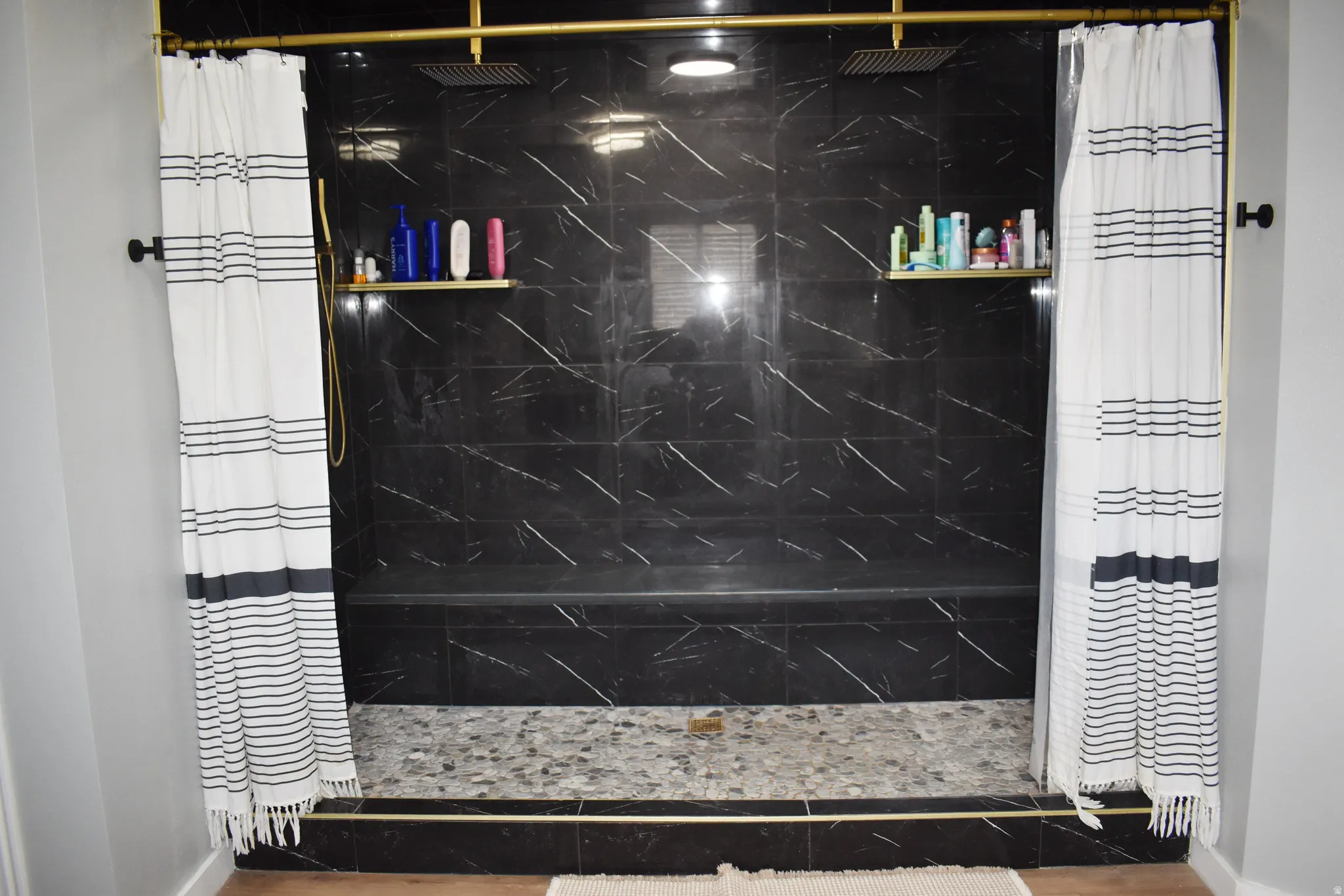 Bathroom with a marble finish shower
