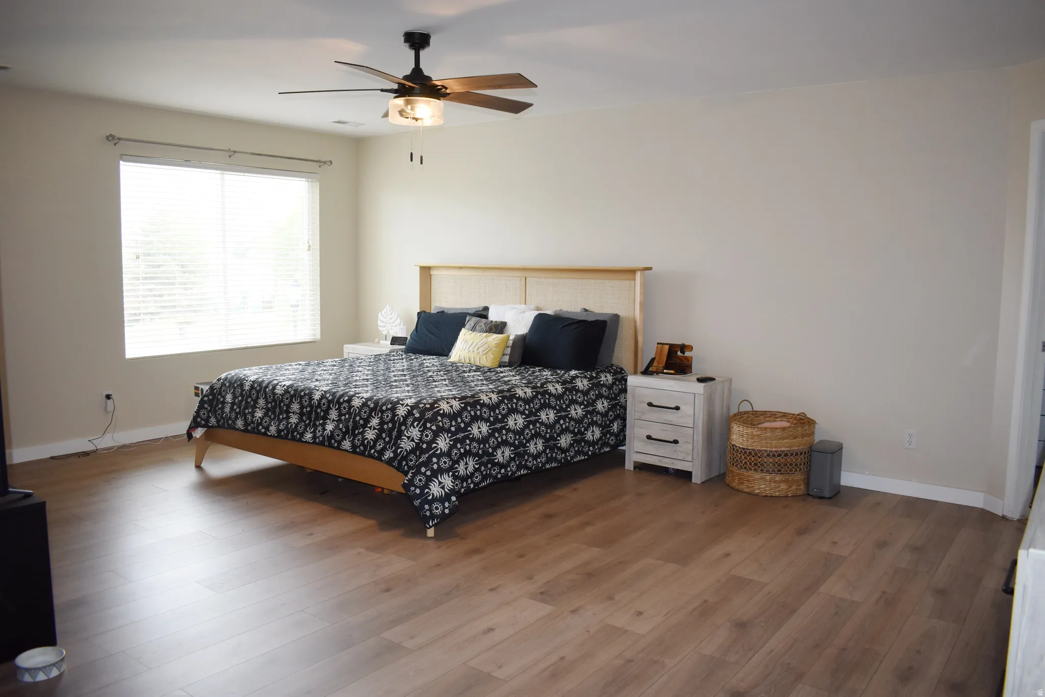 Bedroom with ceiling fan and wood finished floors