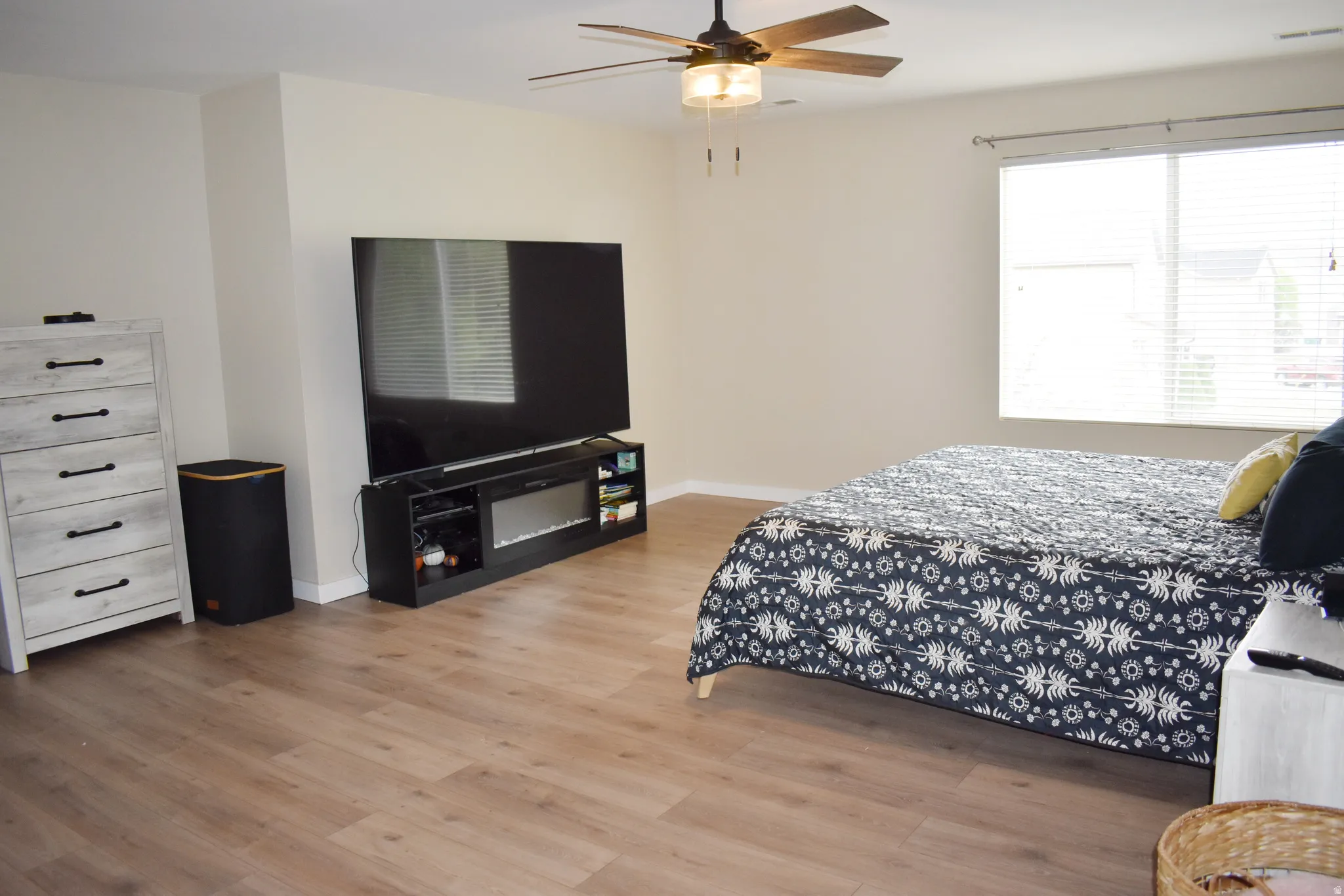 Bedroom with light wood-type flooring and a ceiling fan