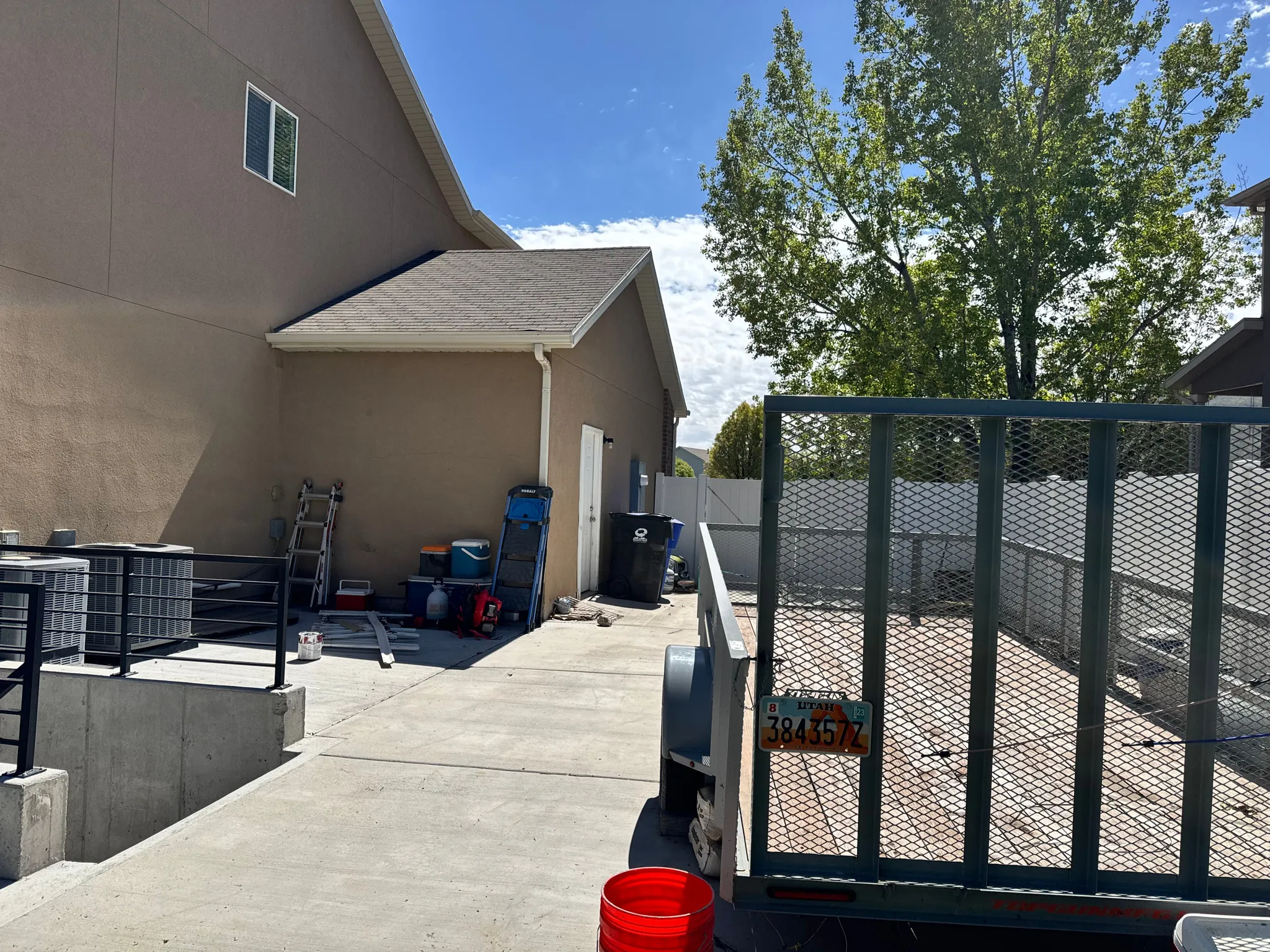 View of side of property with a fenced backyard and stucco siding