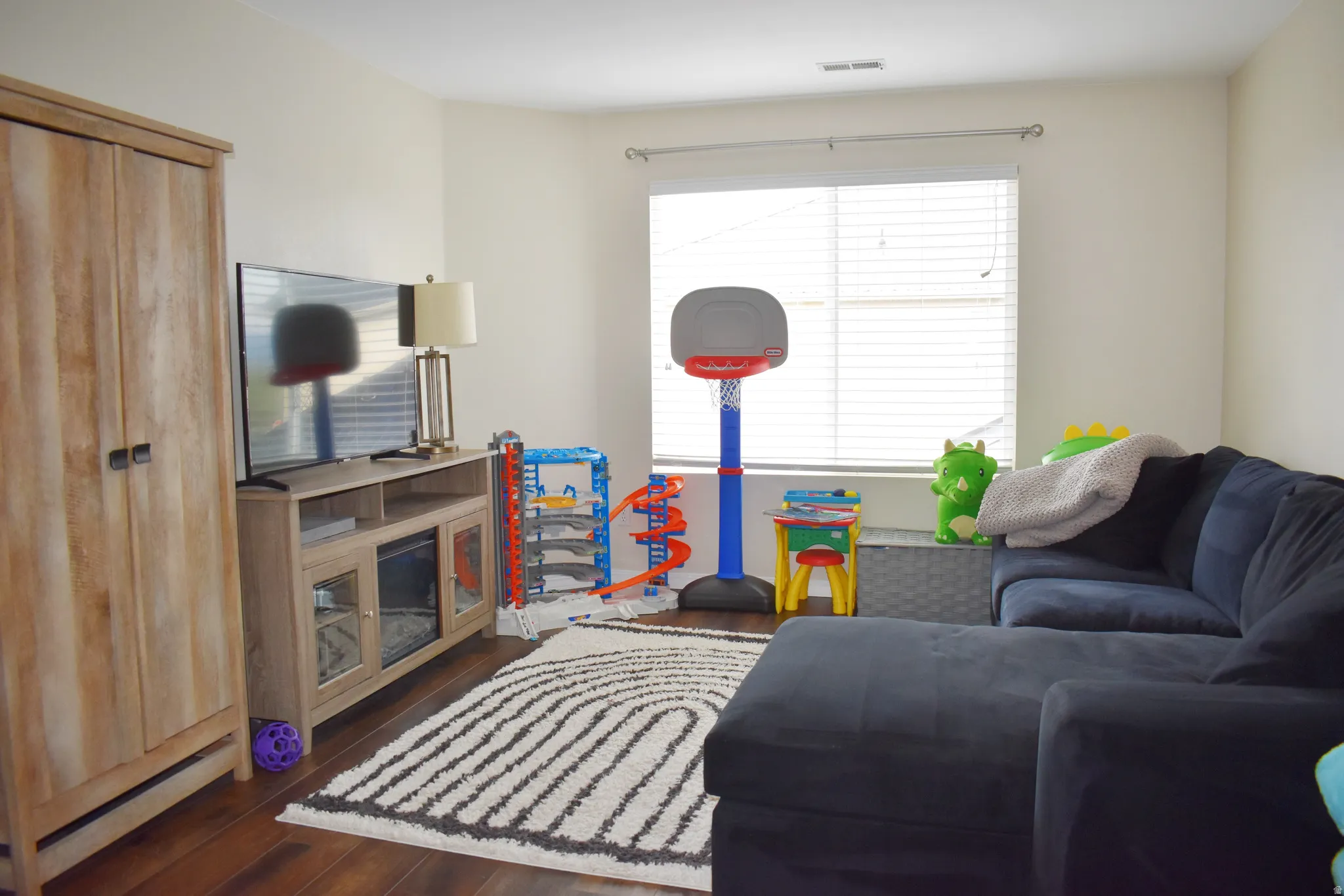 Living area with dark wood-type flooring