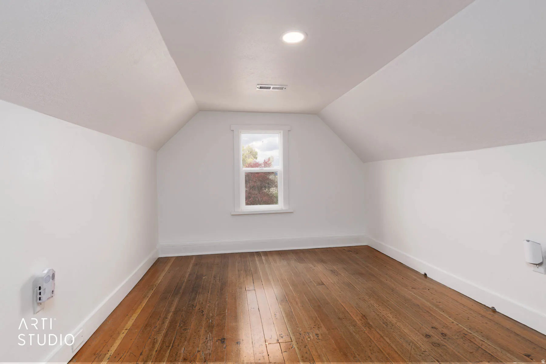 Bonus room featuring baseboards and wood-type flooring