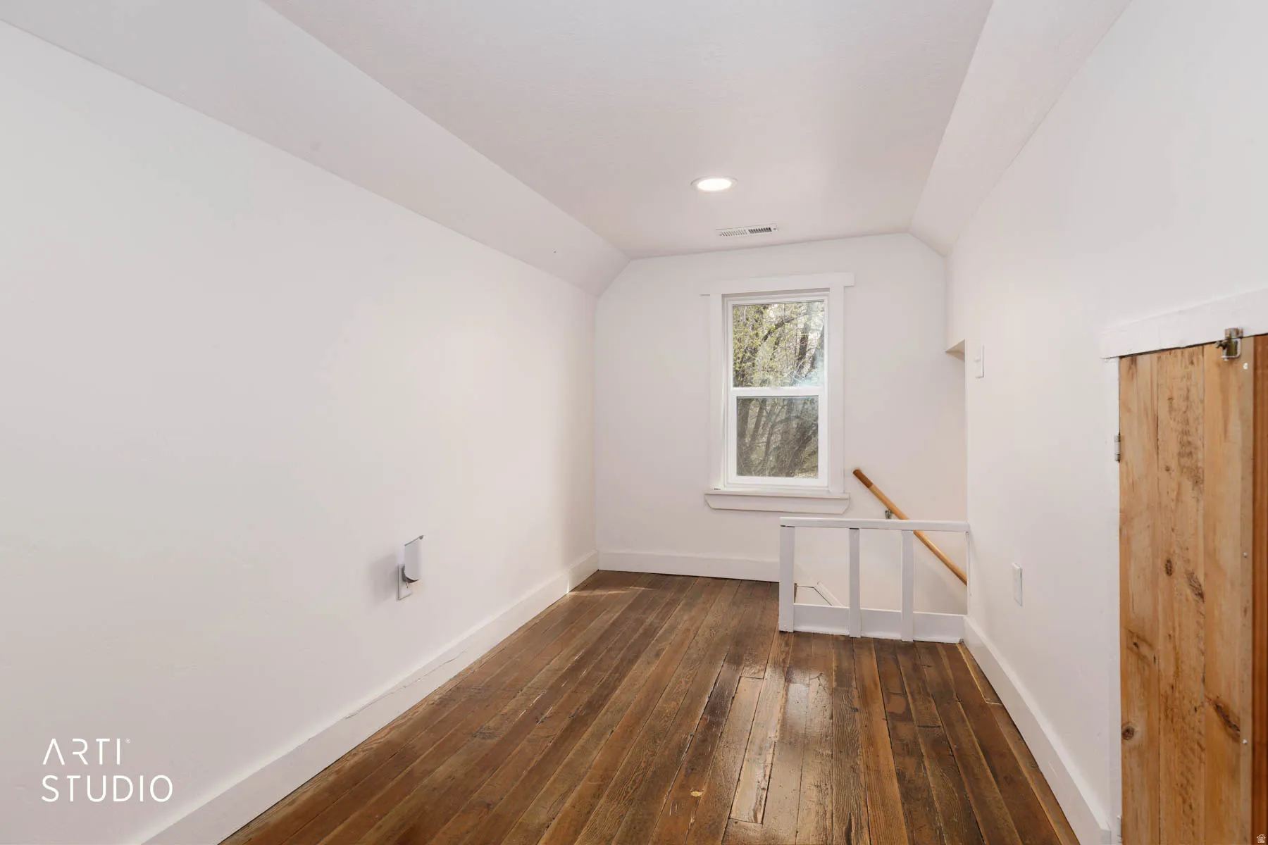 Additional living space featuring dark wood finished floors and lofted ceiling