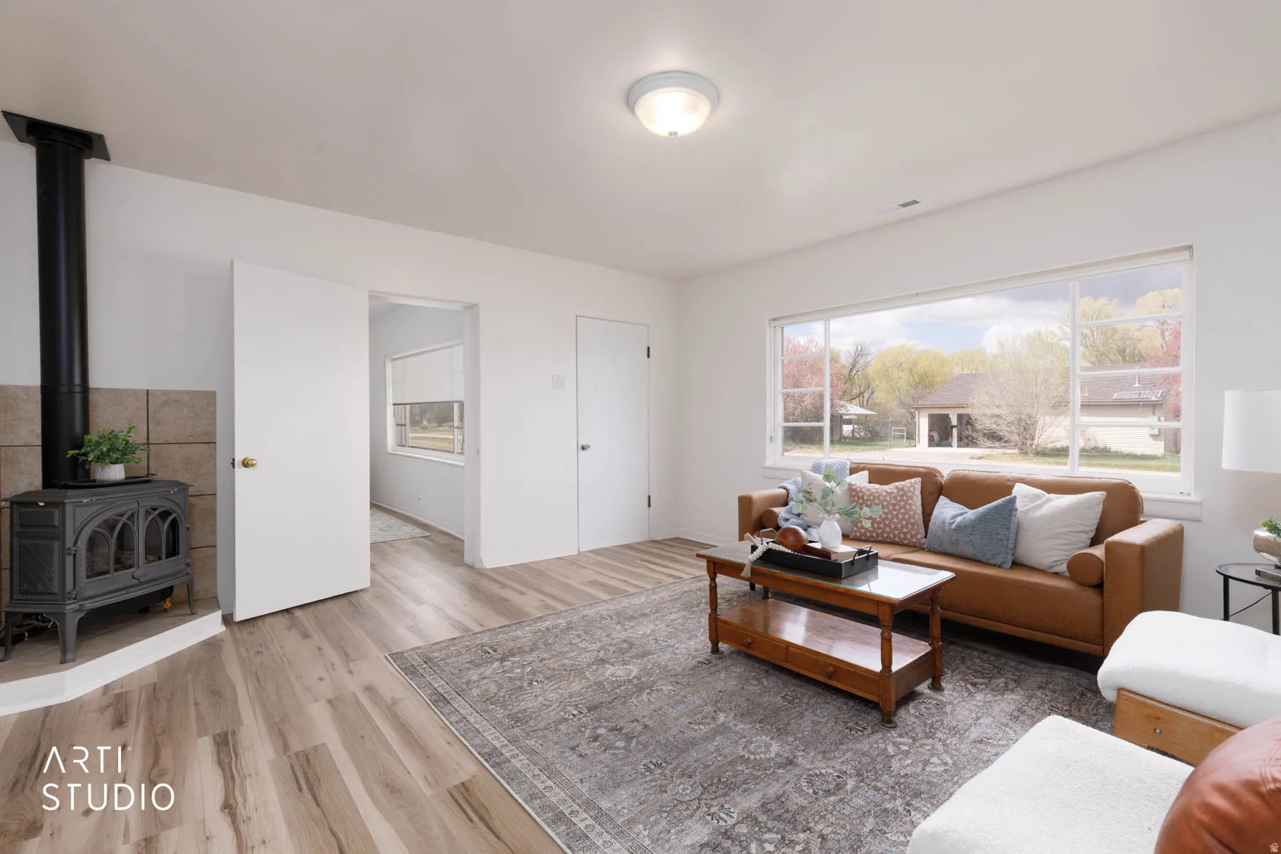 Living area with a wood stove and light wood-style flooring