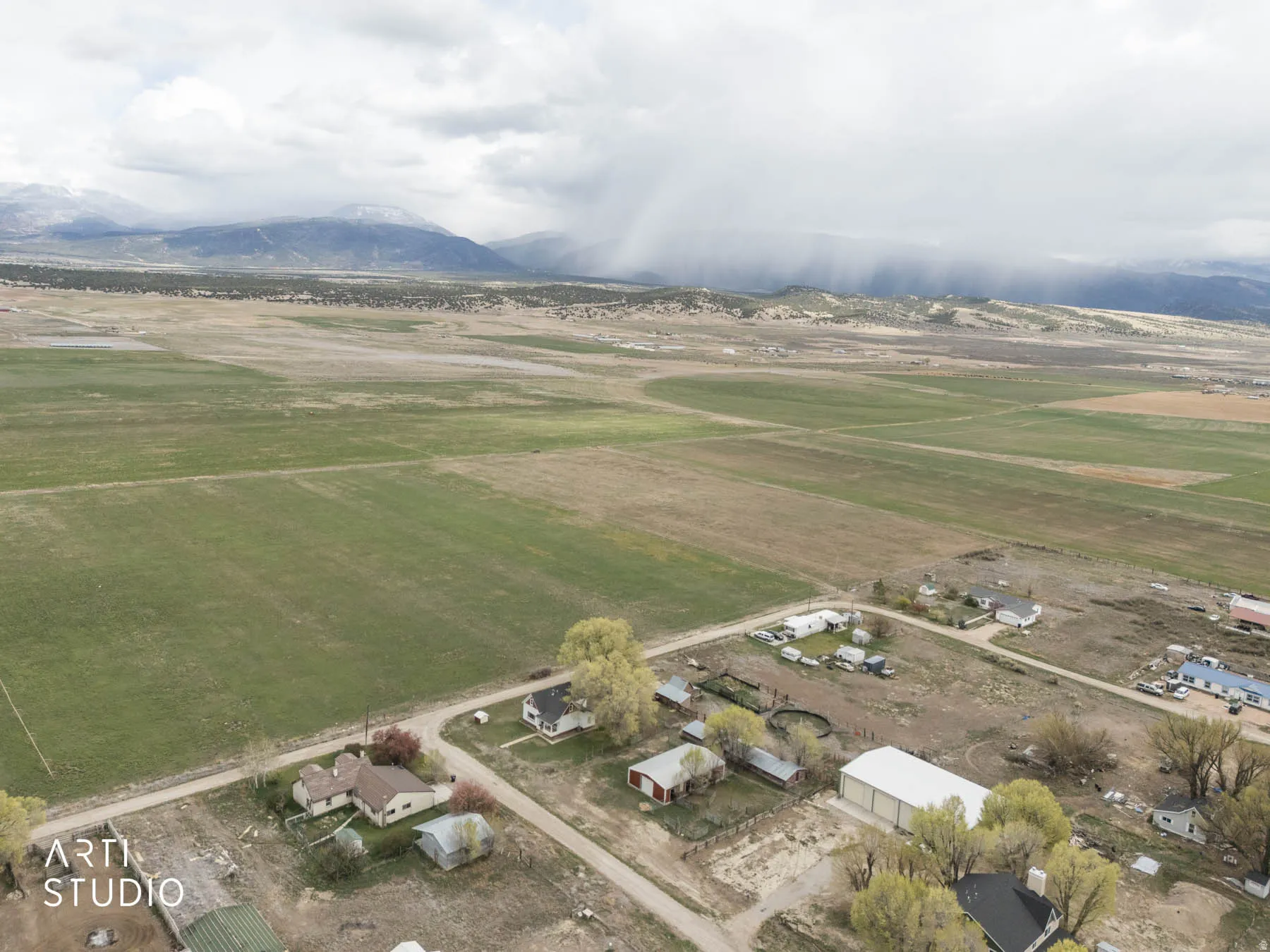 View of rural area featuring a mountainous background and farmland