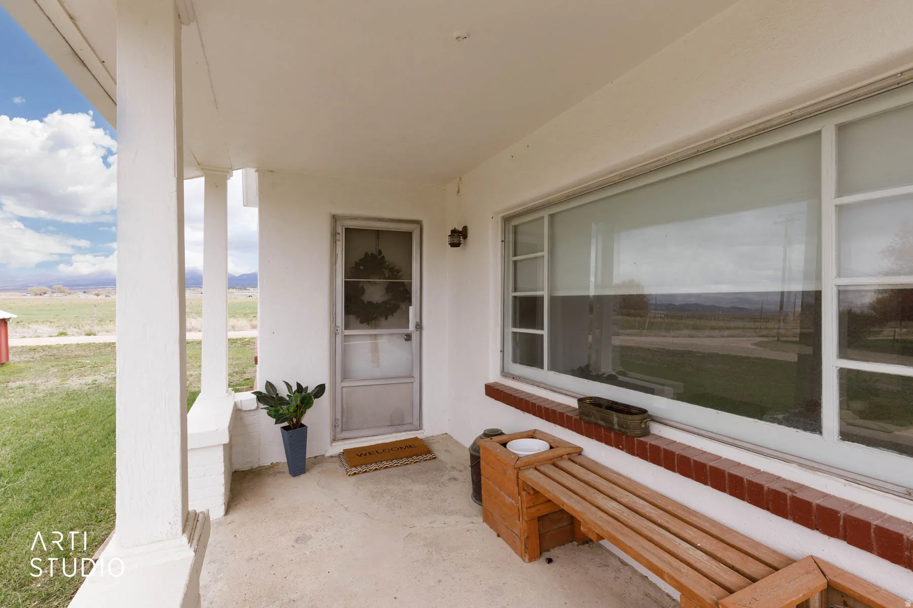 Entrance to property featuring covered porch