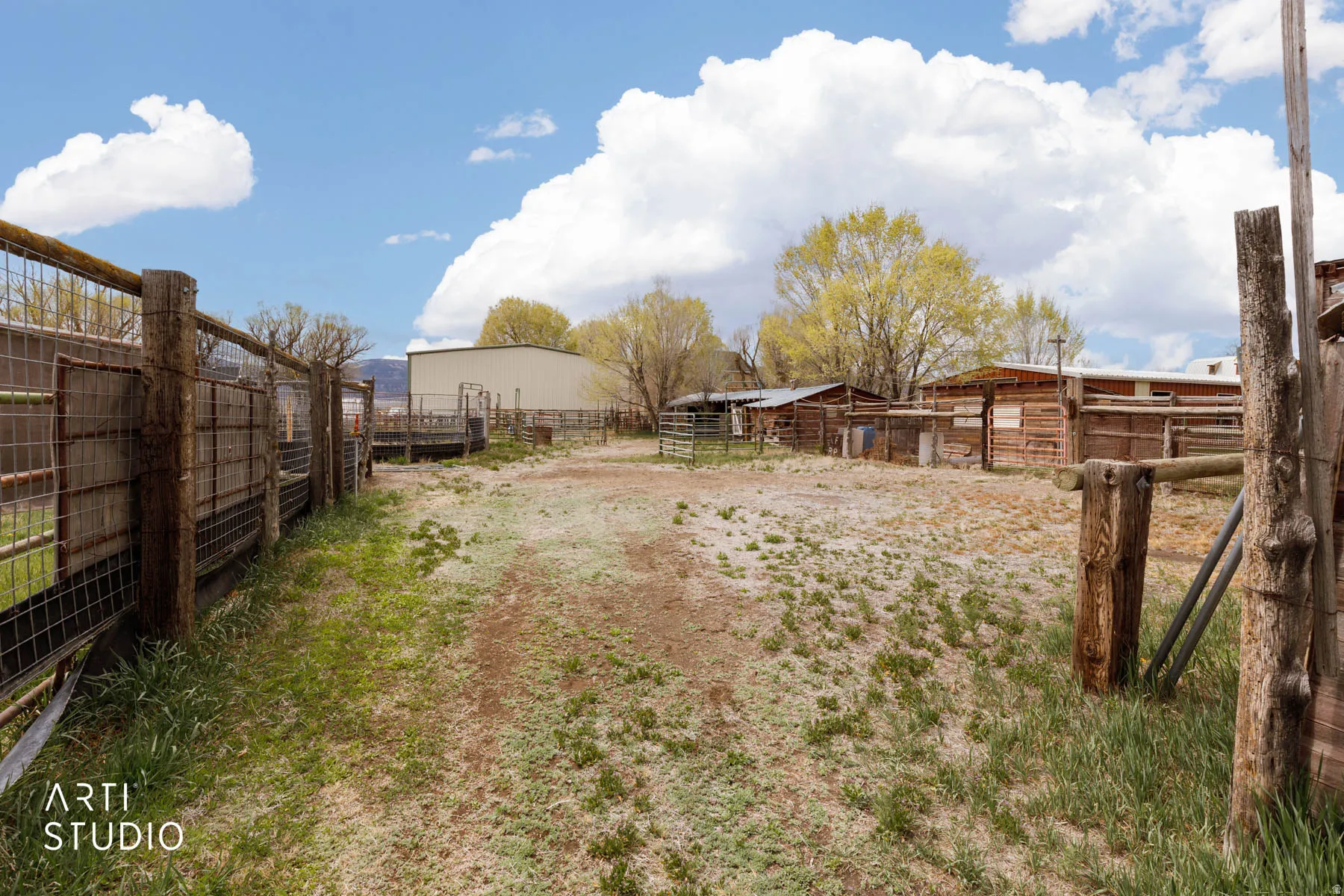 View of yard with an outbuilding, an exterior structure, and a rural view