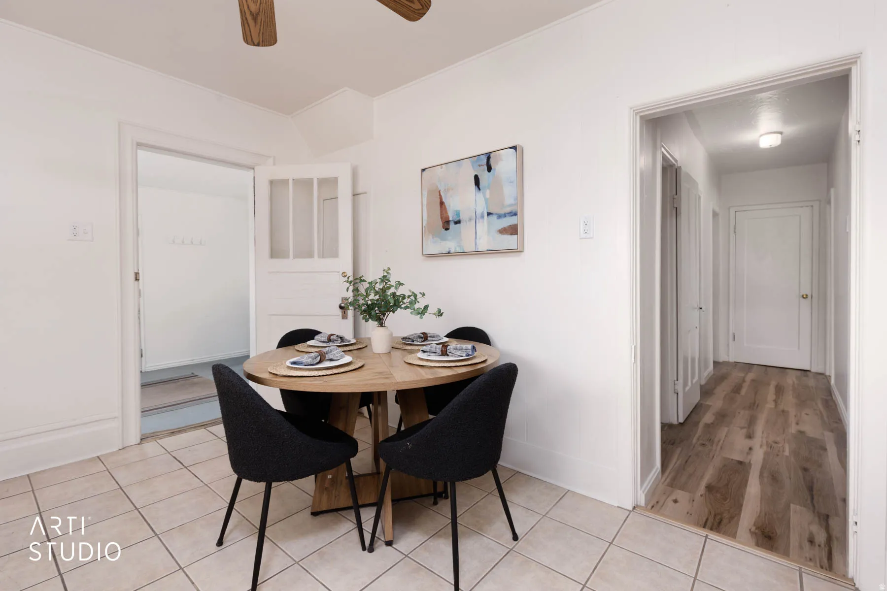 Dining space featuring light tile patterned floors and a ceiling fan