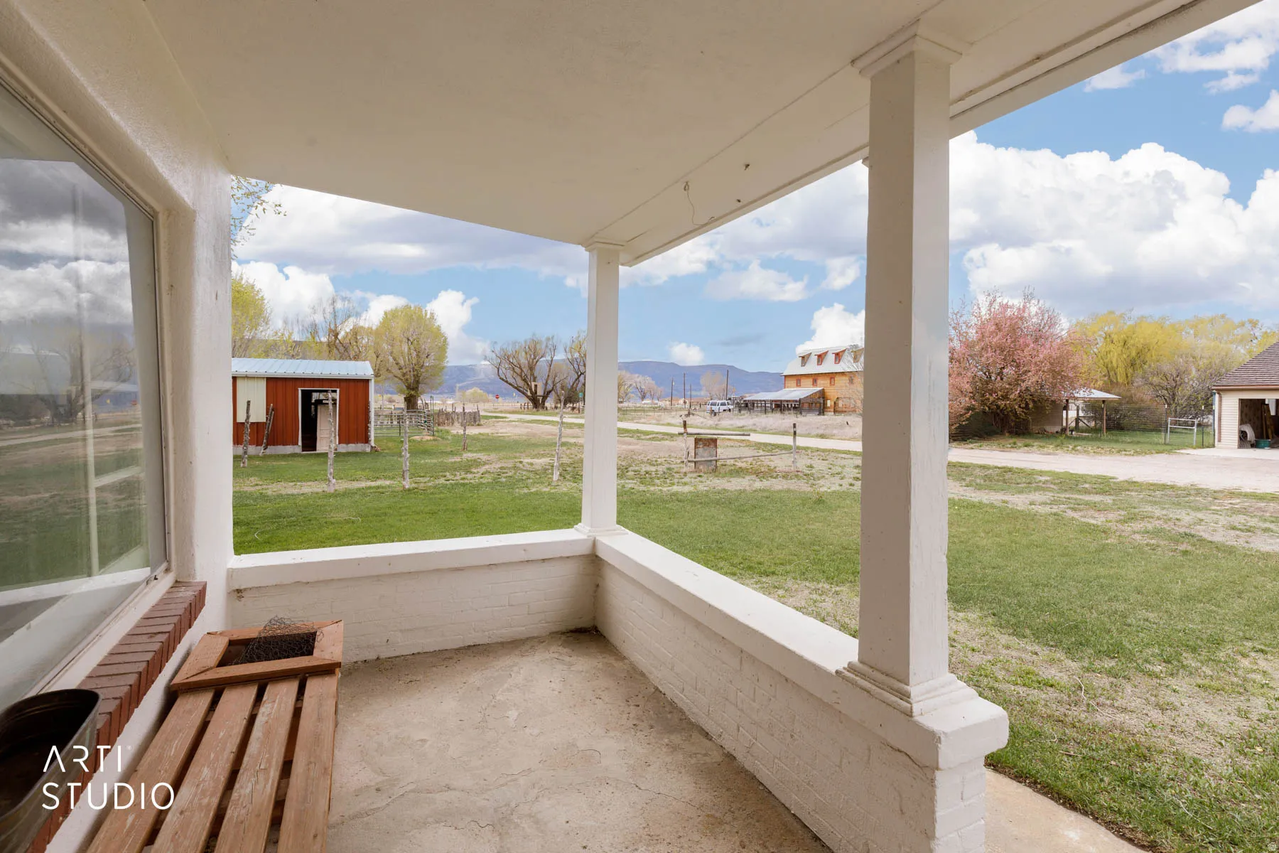 Unfurnished sunroom with a porch and a mountain view