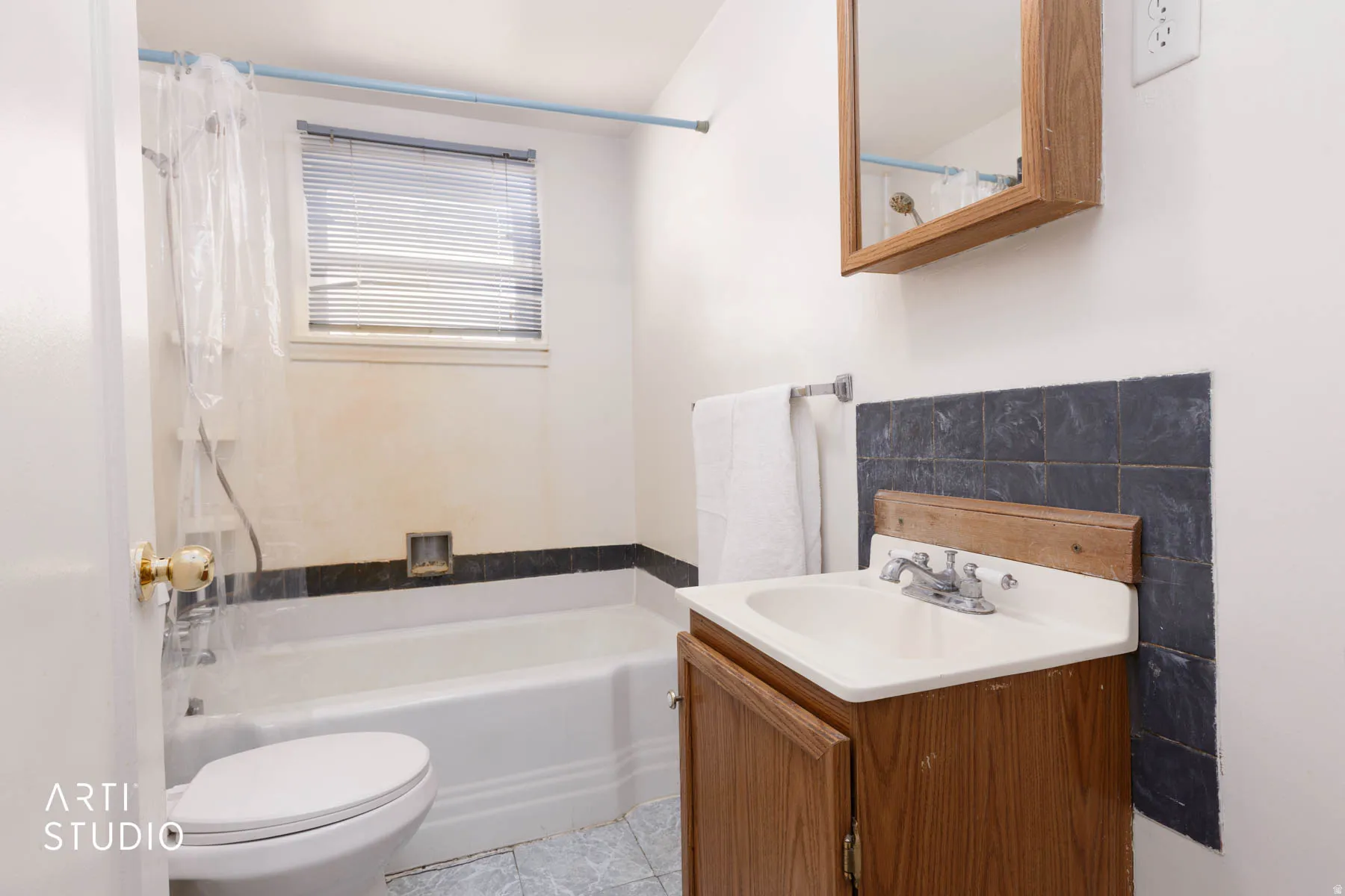 Full bath with vanity, shower / tub combo, and light tile patterned floors