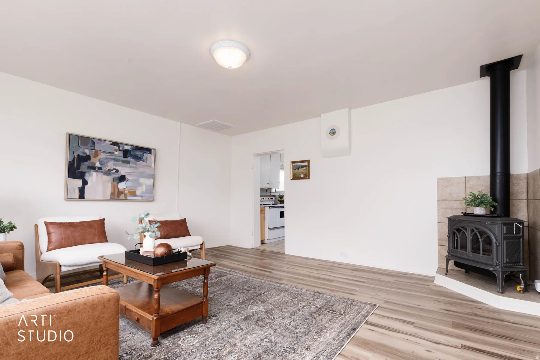 Living area with a wood stove and wood finished floors