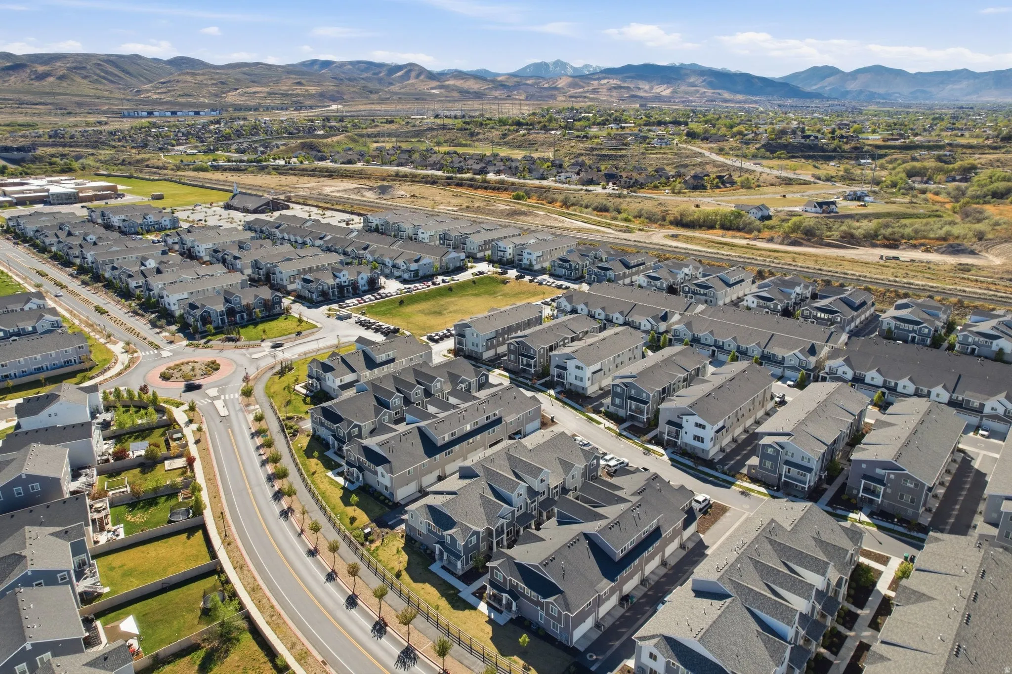 Aerial view of property and surrounding area with nearby suburban area