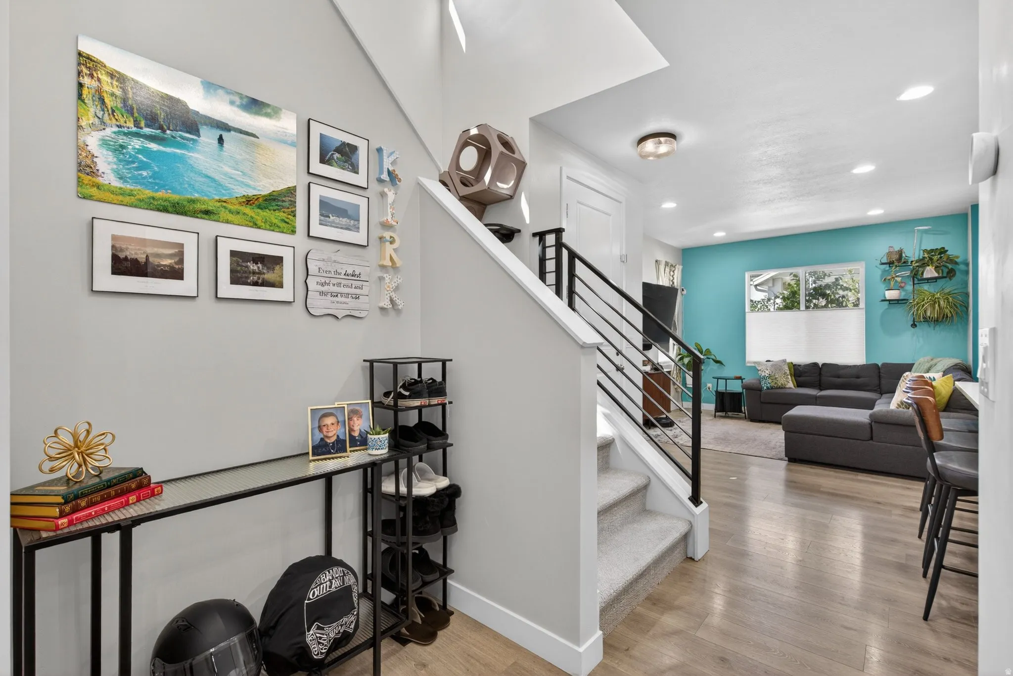 Stairs with wood finished floors and recessed lighting