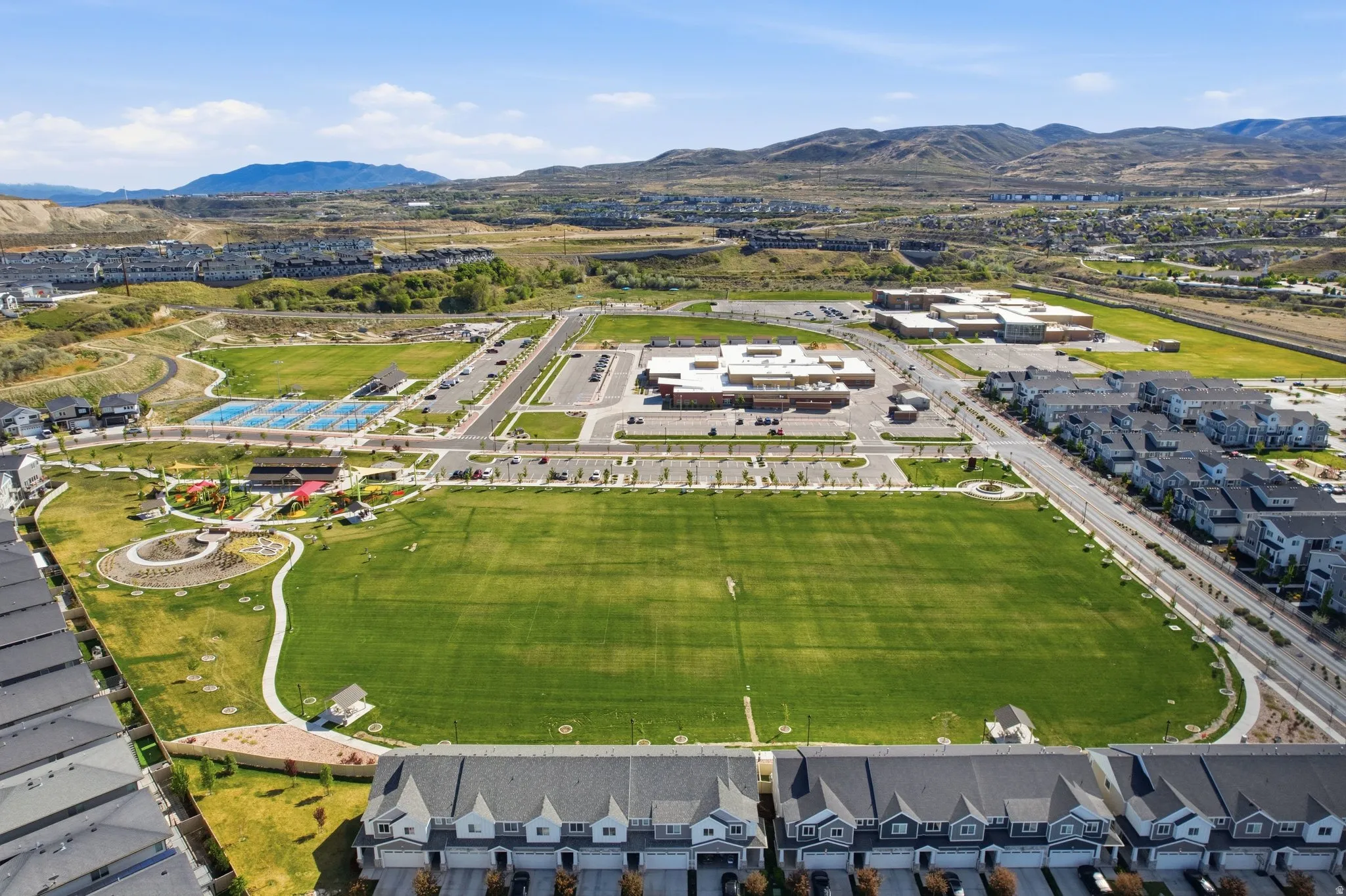 Aerial view of property's location with a mountainous background and nearby suburban area