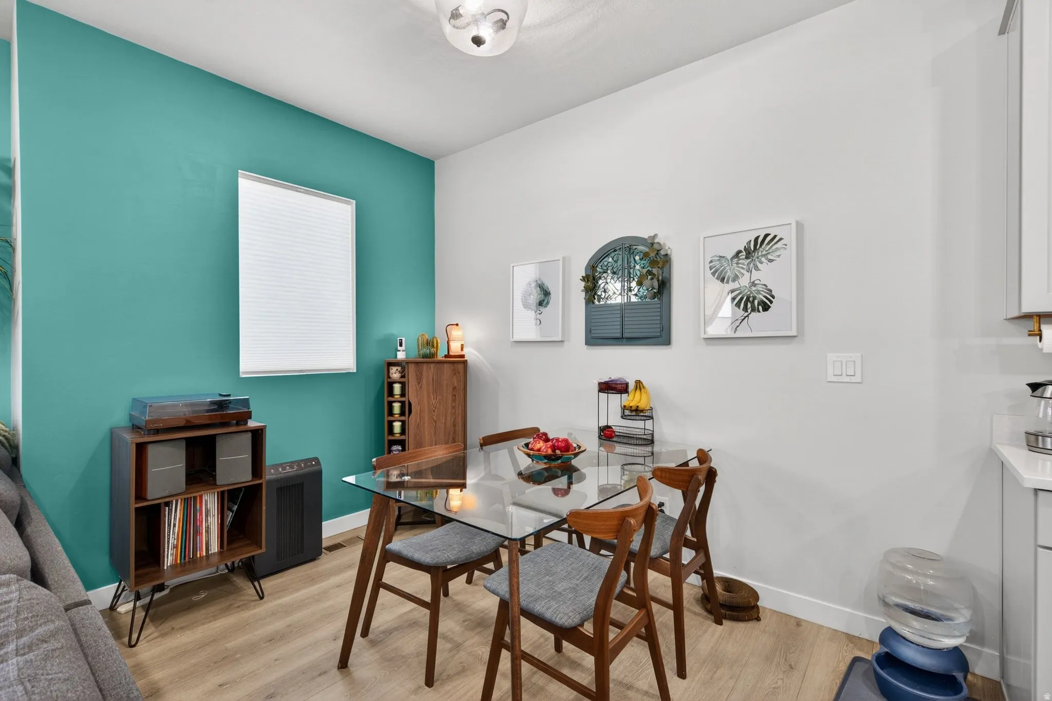 Dining area featuring light wood-type flooring and baseboards