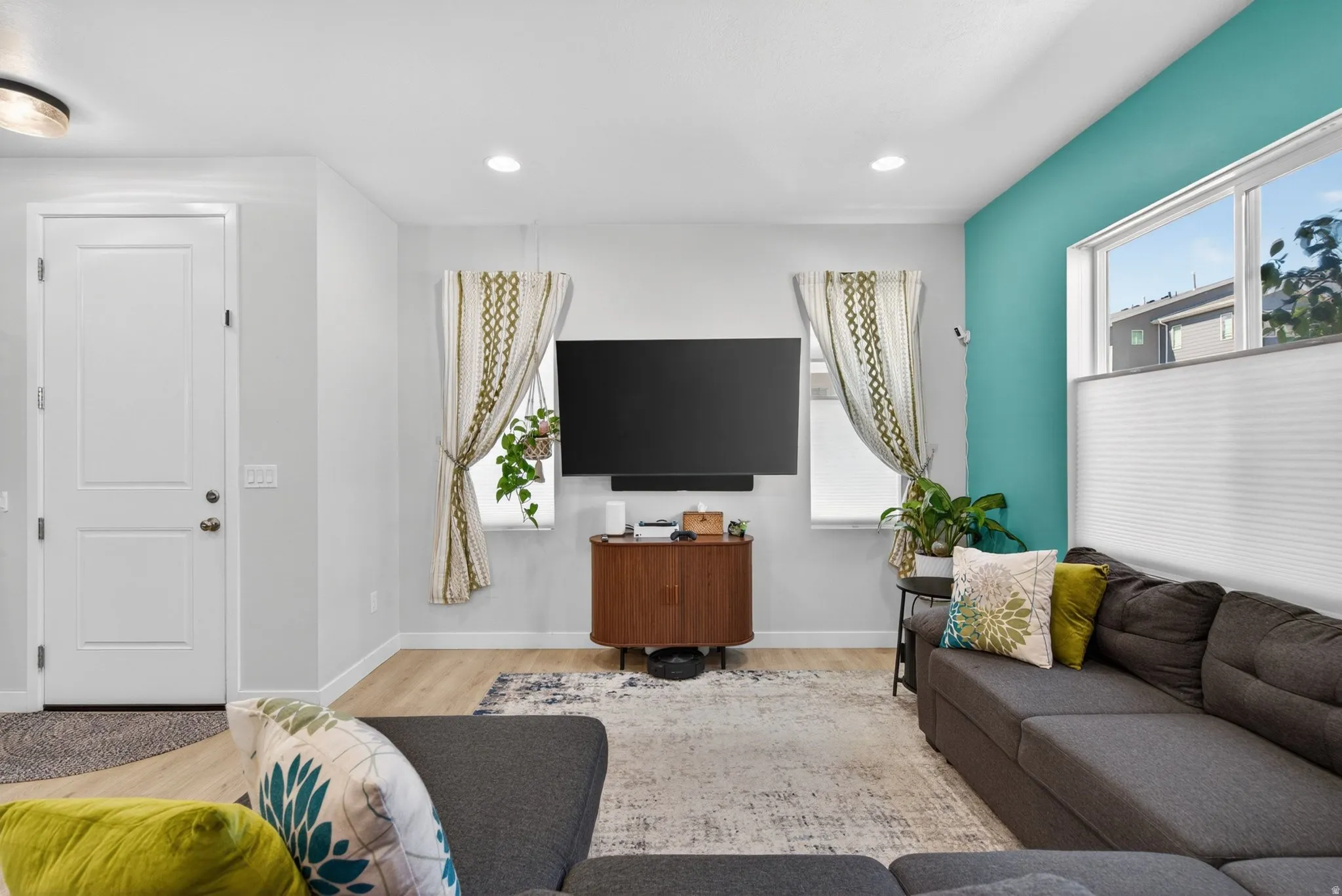 Living room featuring light wood finished floors and recessed lighting