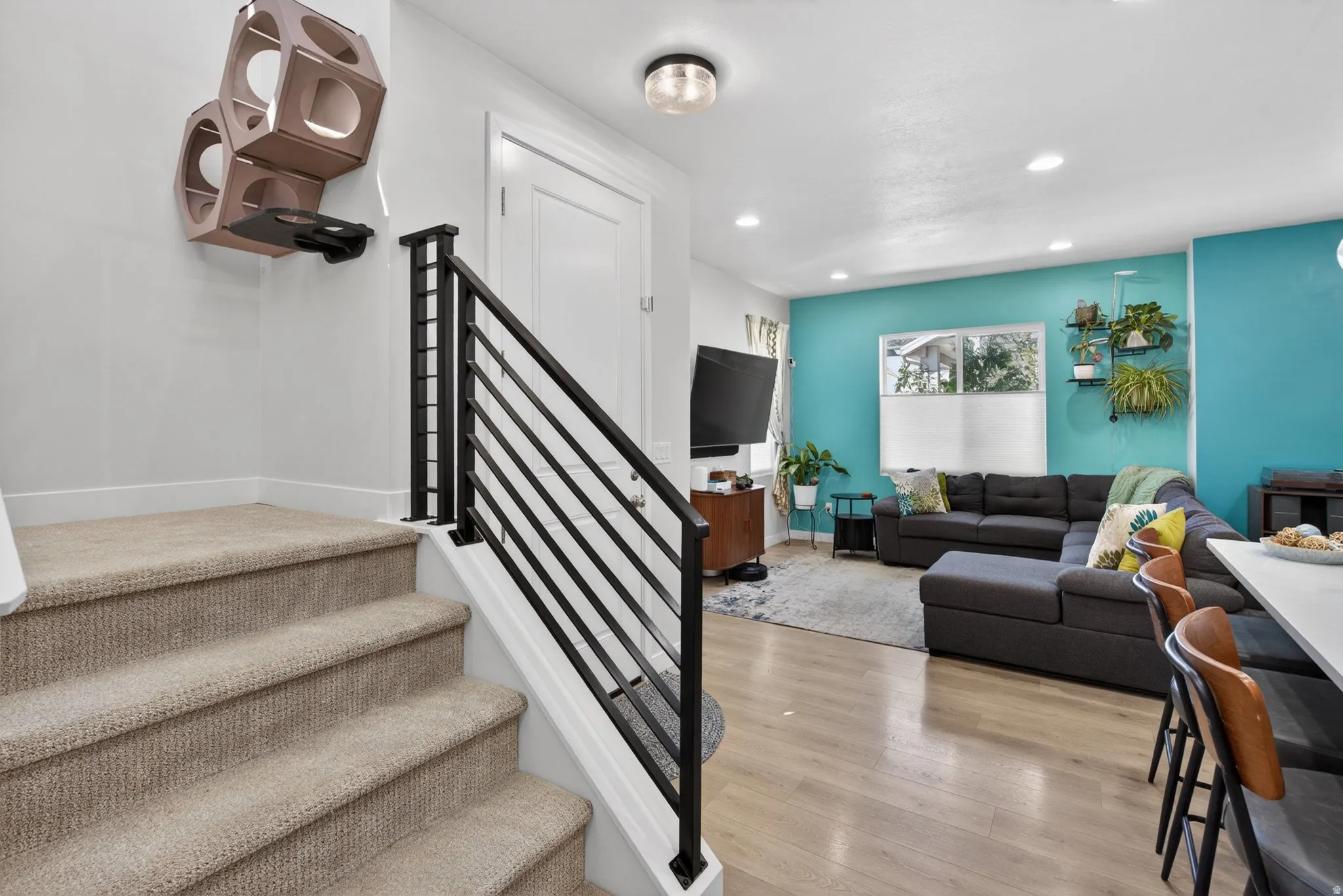 Stairway featuring wood finished floors and recessed lighting