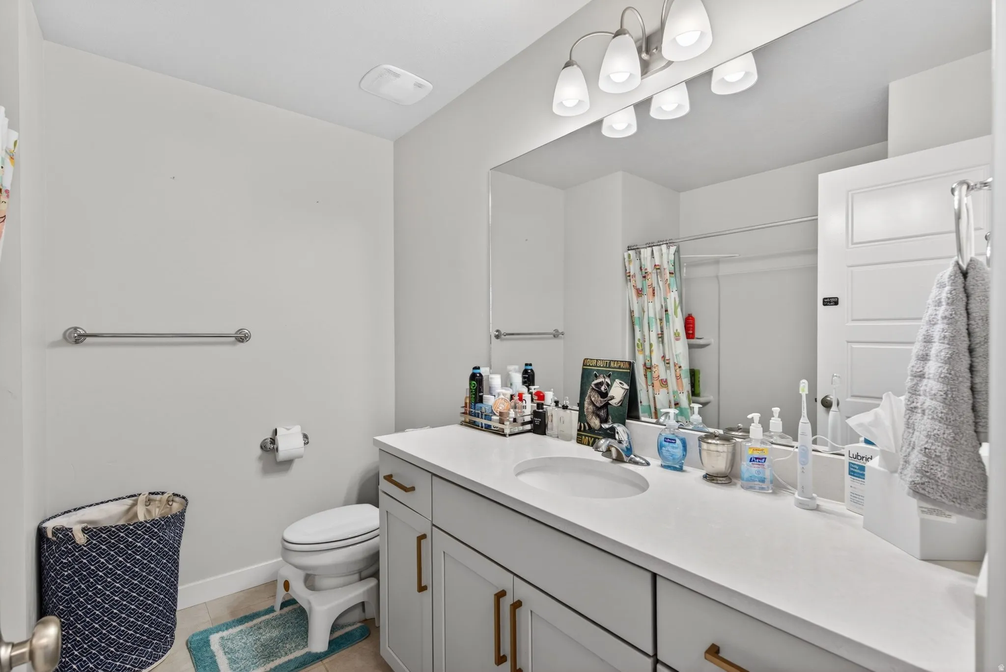 Bathroom with vanity, a shower with curtain, and light tile patterned floors