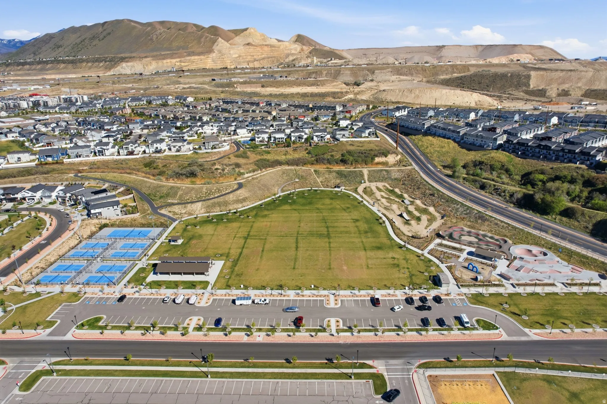 Aerial view of property's location featuring nearby suburban area and mountains