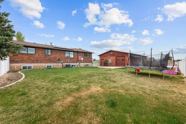 Fenced yard with a patio and a trampoline