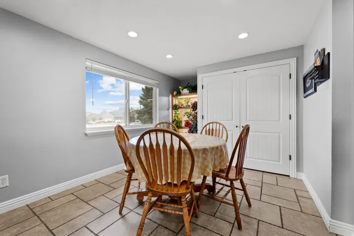 Dining area with recessed lighting and stone tile flooring