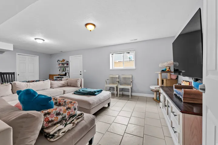 Living room with baseboards and a textured ceiling