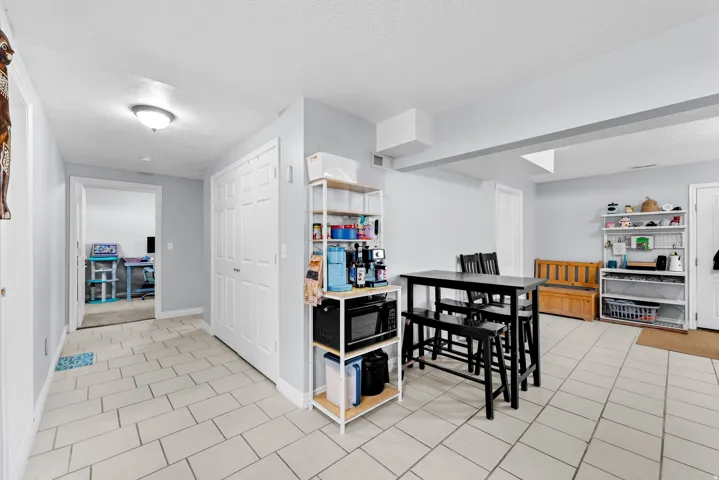 Kitchen featuring a textured ceiling and light tile patterned floors