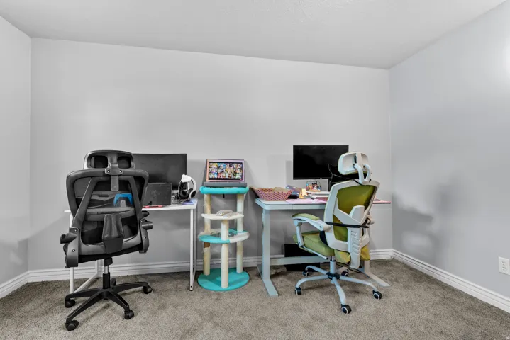 Office space featuring light colored carpet and baseboards