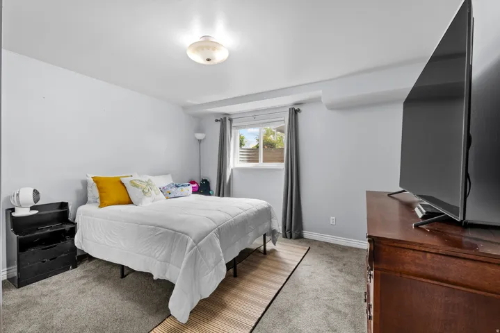 Carpeted bedroom featuring baseboards