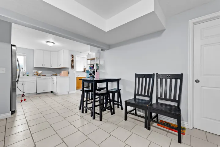 Dining area with baseboards and light tile patterned floors