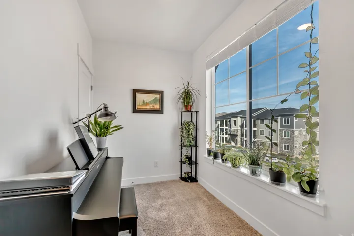 Unfurnished office with baseboards and light colored carpet