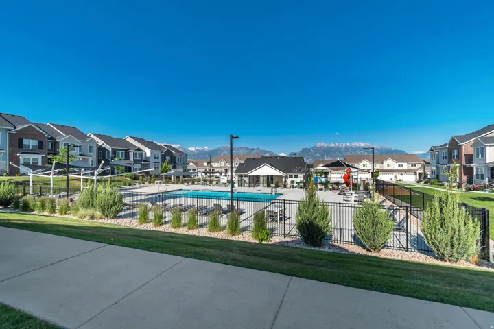 Community pool with a residential view