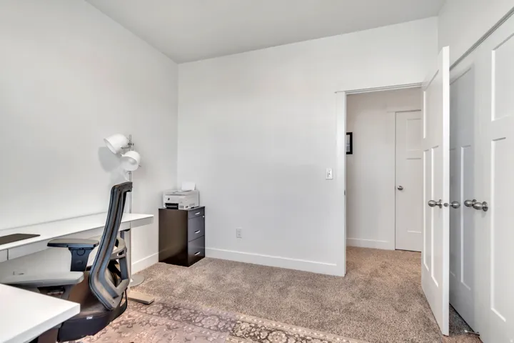 Unfurnished office featuring light colored carpet and baseboards