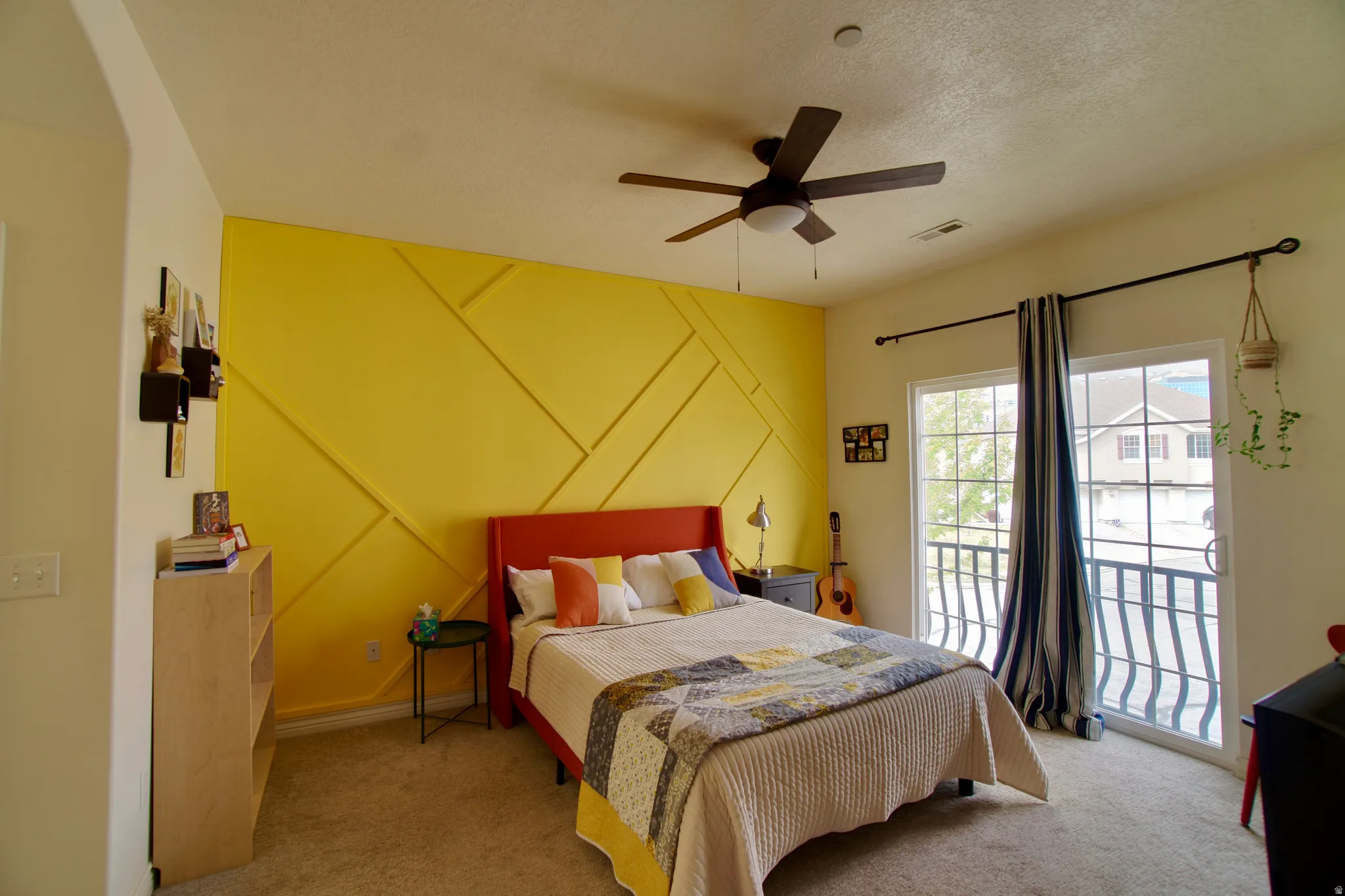 Bedroom featuring carpet flooring, access to exterior, a ceiling fan, and a textured ceiling
