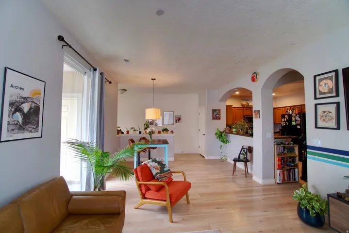 Living area featuring light wood-type flooring and arched walkways