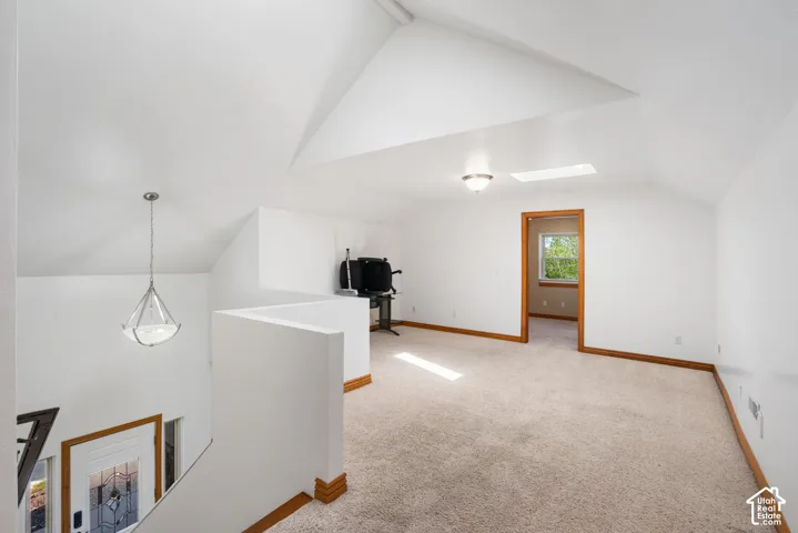 Bonus room featuring light carpet and a skylight